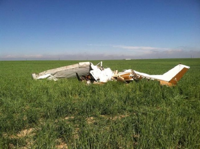 The wreckage of a crashed Cessna 150 airplane lies in a field near Watkins, Colorado on May 31, 2014. REUTERS/Sgt Aaron Pataluna/Adams County Sheriff/handout via Reuters