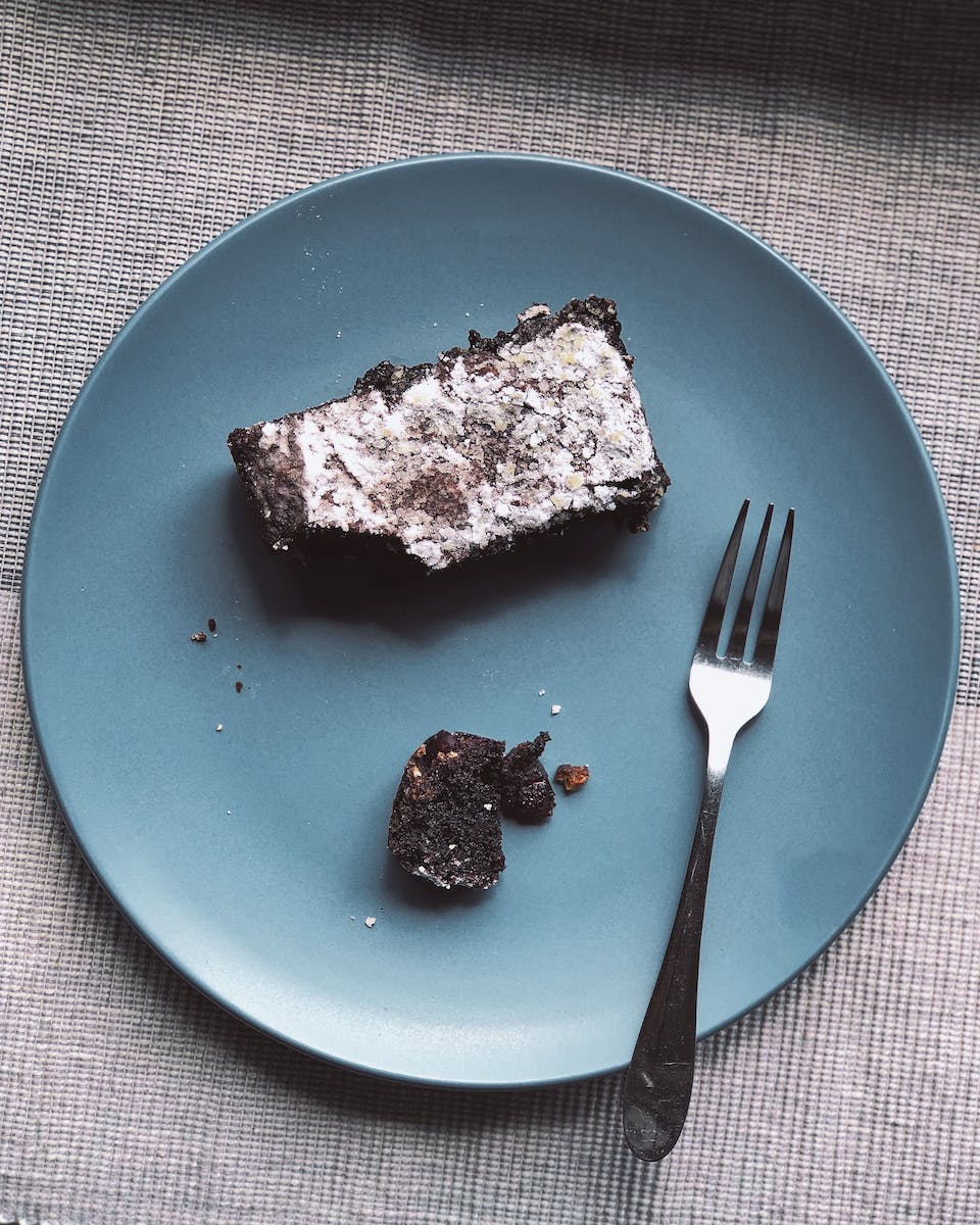 Stainless Steel Fork On Top Of Blue Ceramic Plate