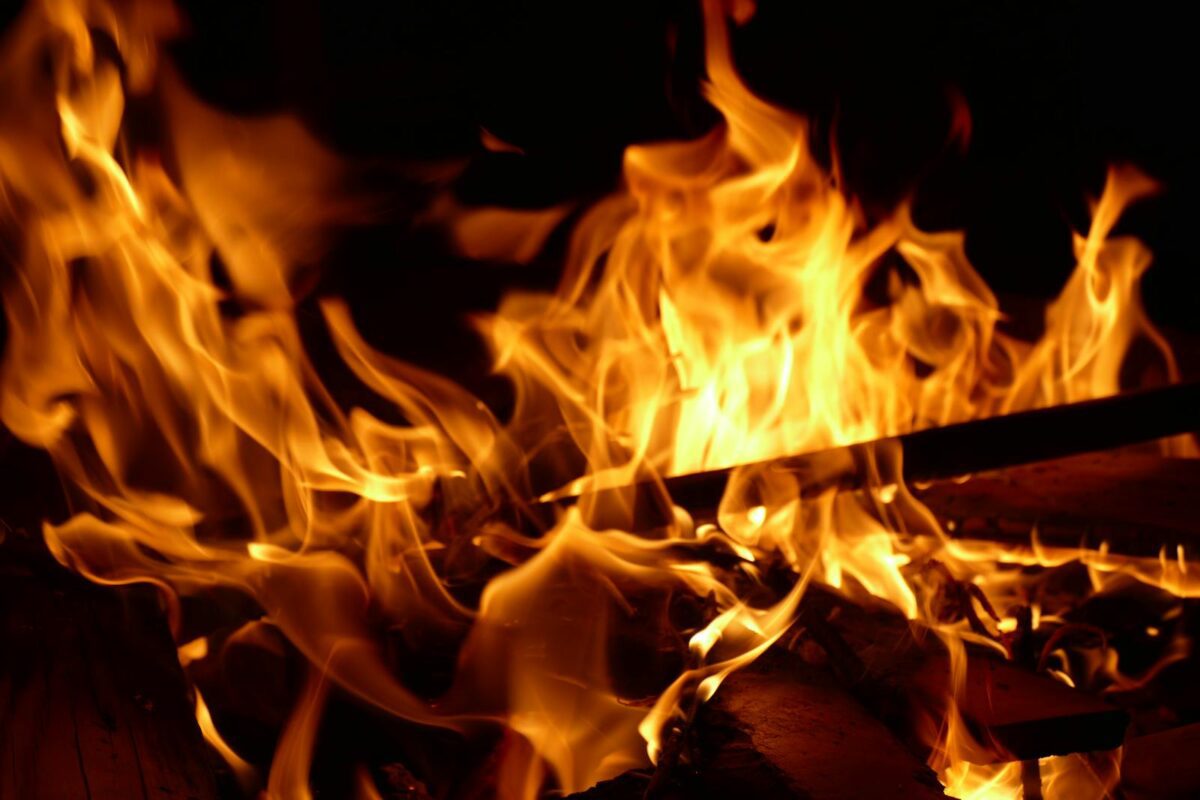 Close-up of a bright campfire burning with intense flames and glowing heat.