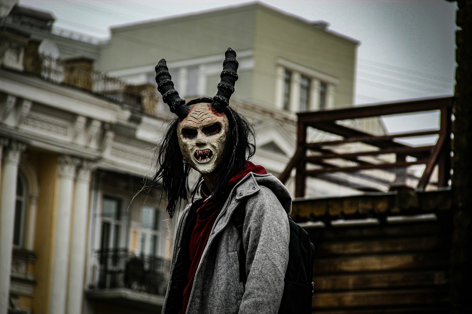 a man wearing a horned mask with long black hair