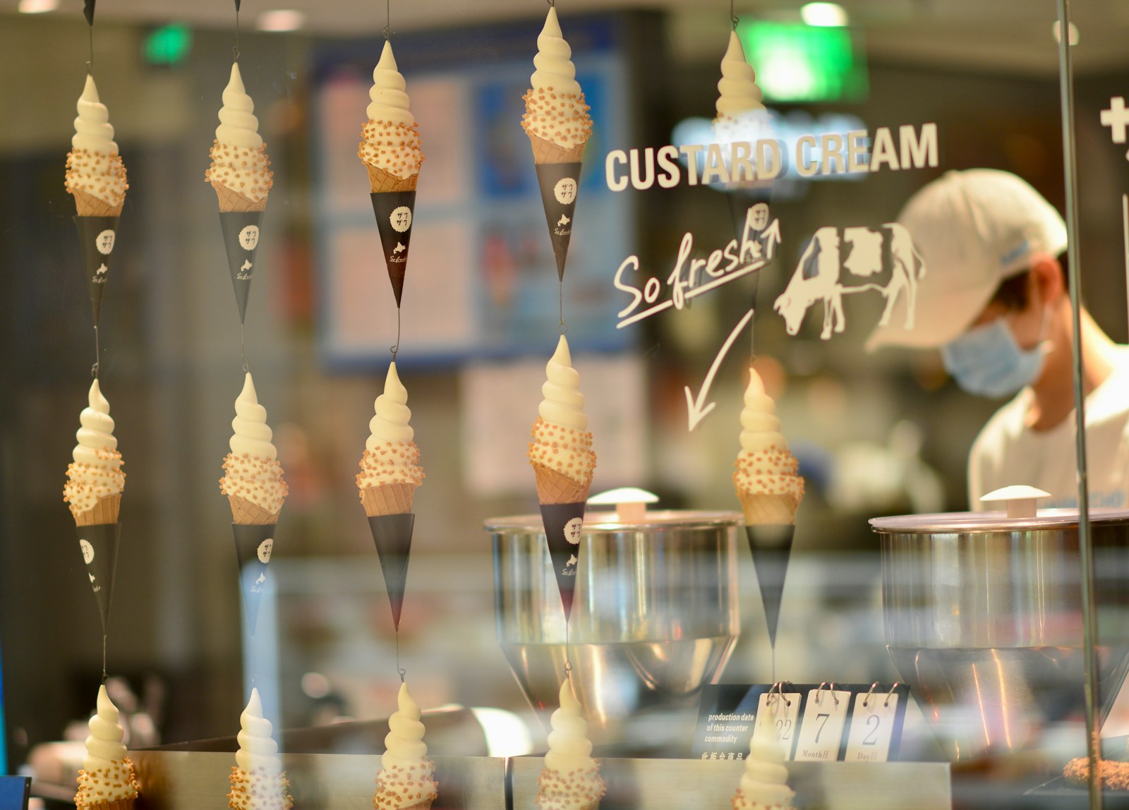 a person behind a counter with many candles