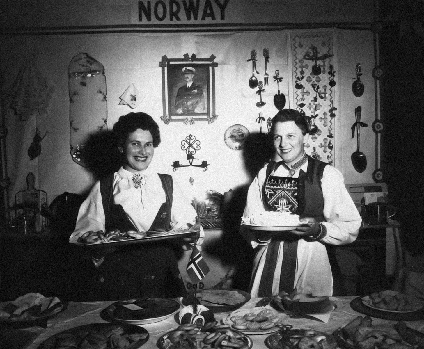 a couple of women standing next to each other in front of a table