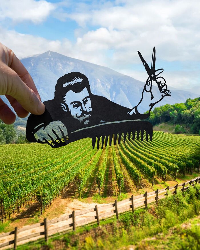 Papierový výrez kaderníka nad vinicou, hory v pozadí, modrá obloha. Kreatívne umenie s prírodou.