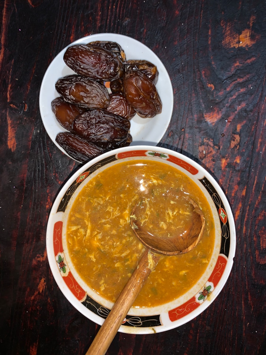 a bowl of soup next to a plate of raisins