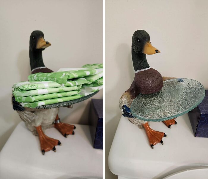 Kačica-držiak na toaletný papier v kúpeľni so sklenenou táckou, na ktorej sú hygienické vložky.