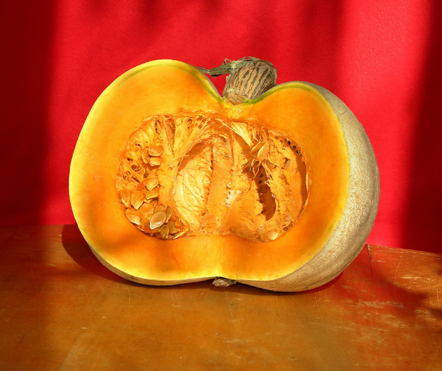 A pumpkin cut in half sitting on a table