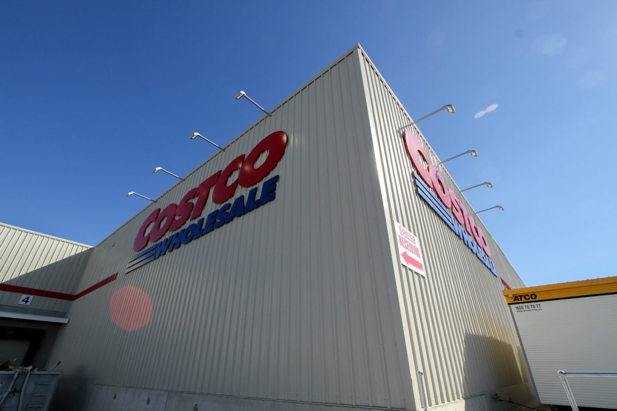 a large white building with a red and blue sign on it