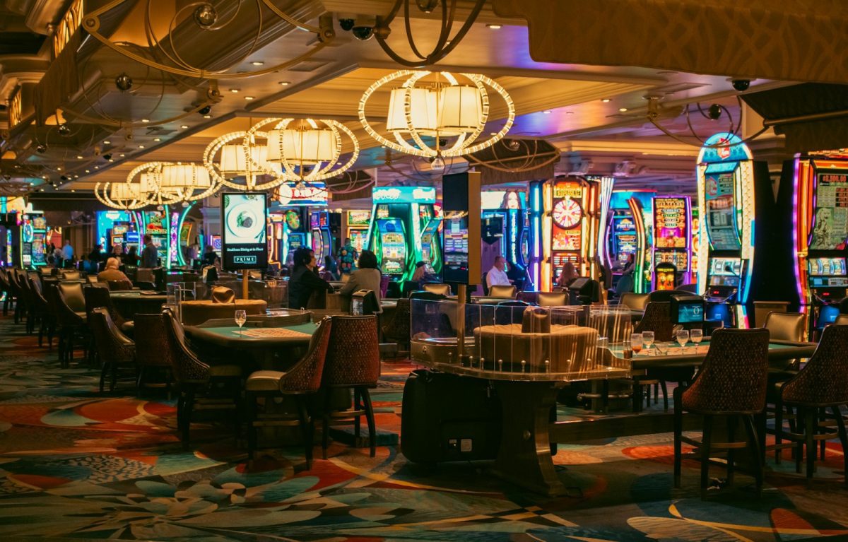 A casino interior with slots and tables is shown.